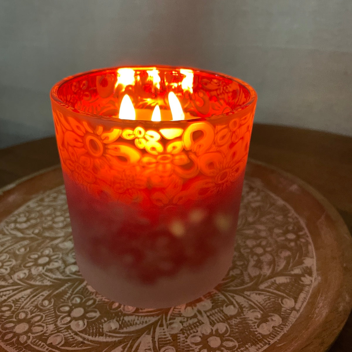 Christmas beeswax candle in red floral glass