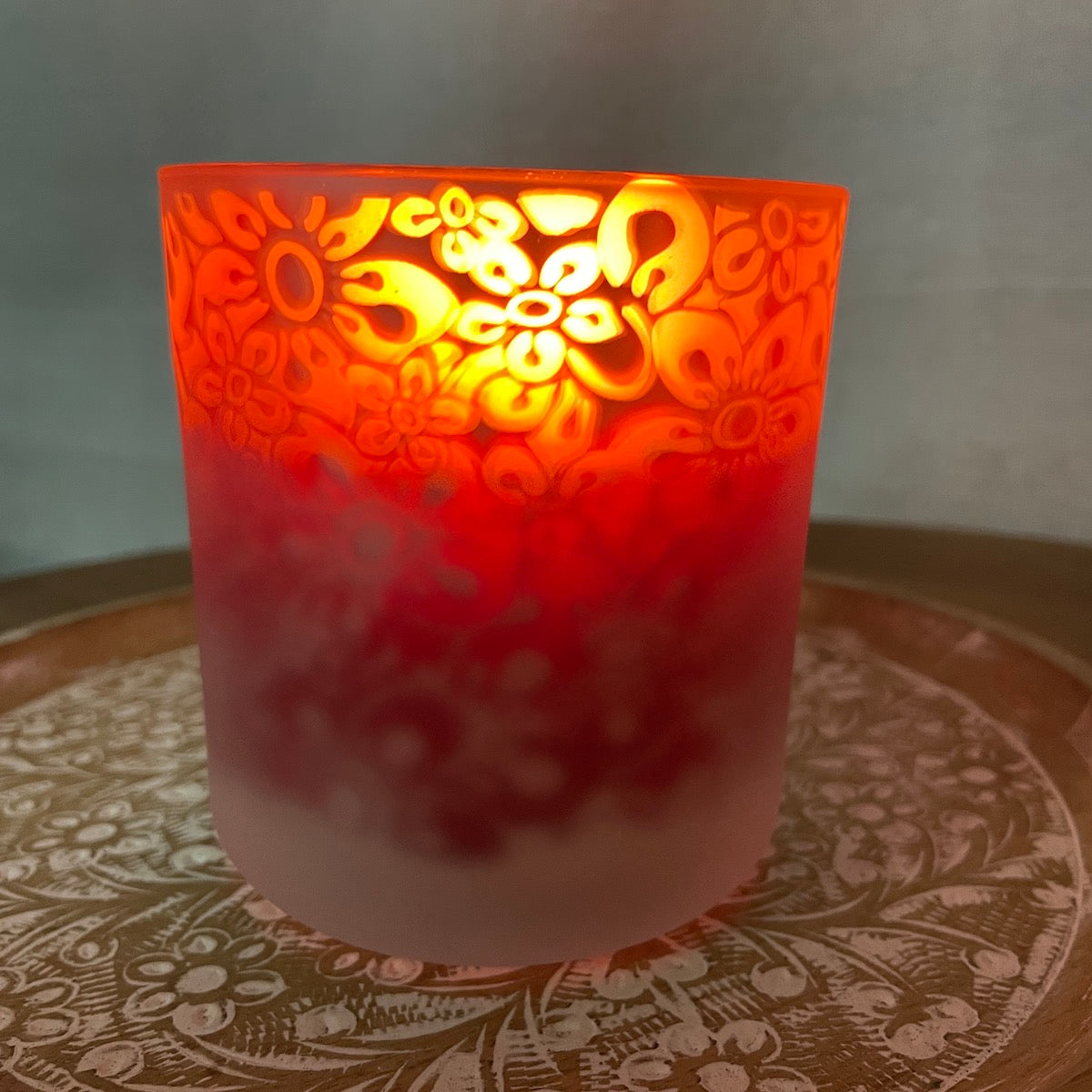 Christmas beeswax candle in red floral glass