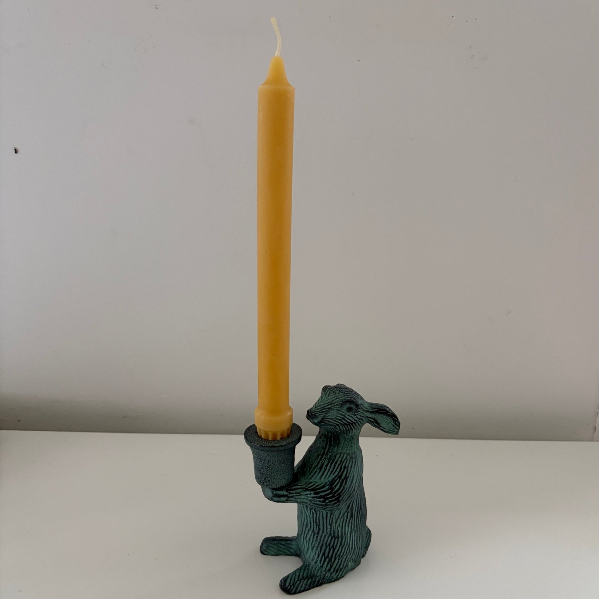 Metal rabbit shaped candle holders with Antique finish holding a candle- Happy Flame