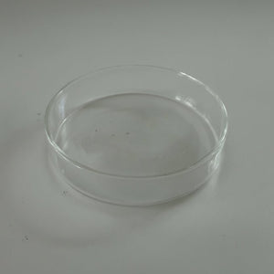 Clear glass dish on a gray background