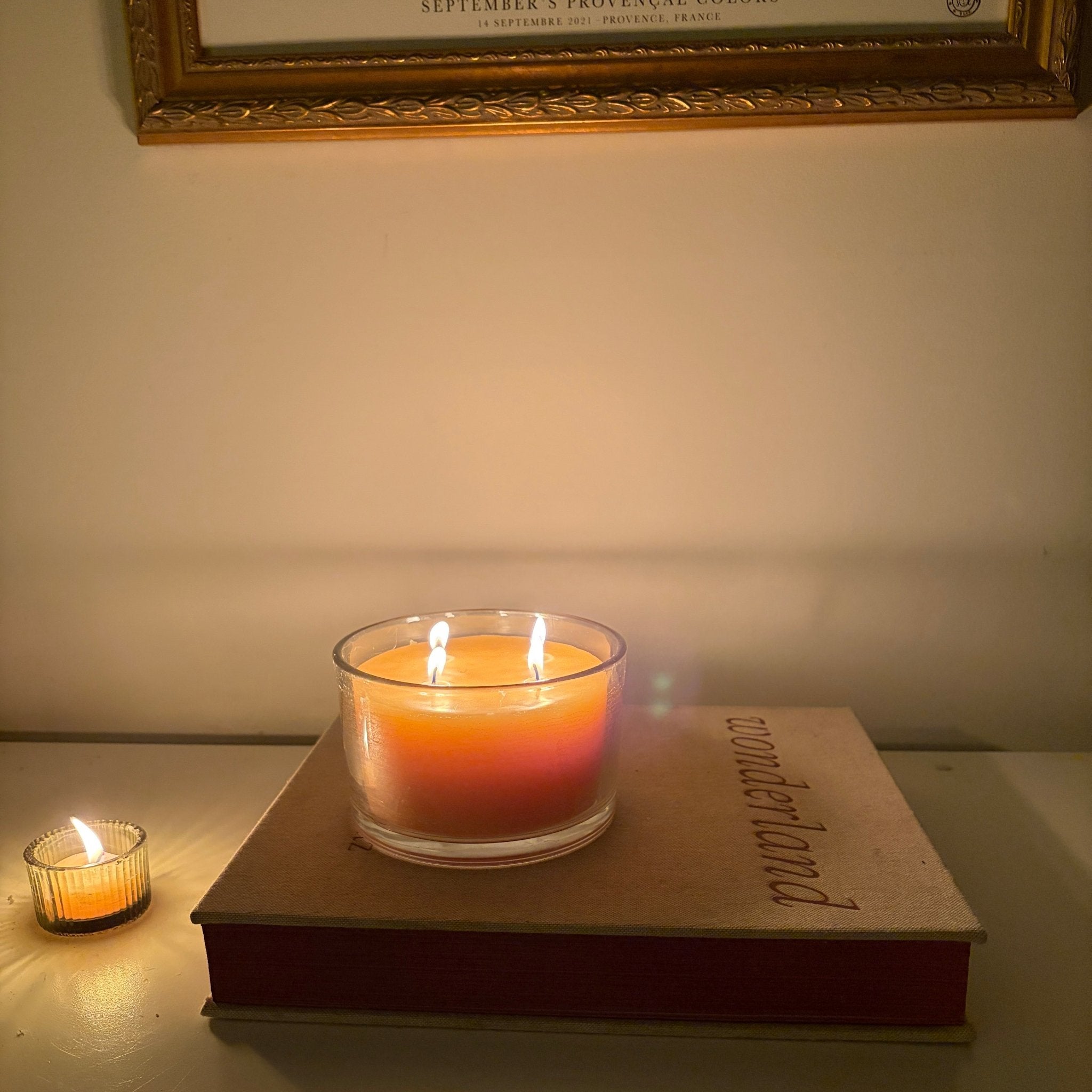 Beeswax four wick candle in glass on a book - Happy Flame