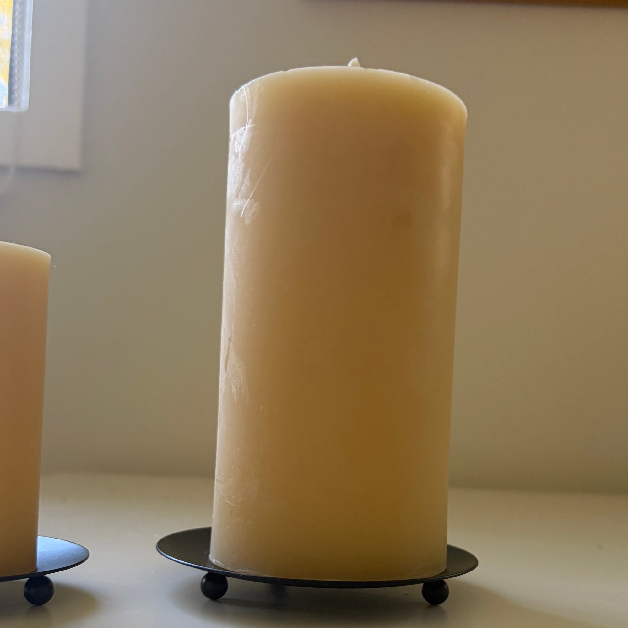 Round black metal candle plate with feet