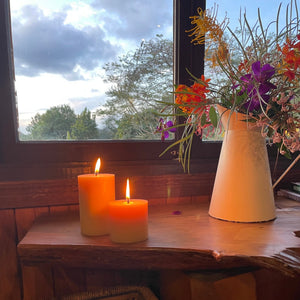 Byron Bay Spirit - Beeswax Pillar Candle - imperfect in a table with flower vase and window on the background  - Happy Flame
